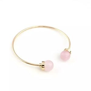 Open bangle bracelet - gold with pink stone